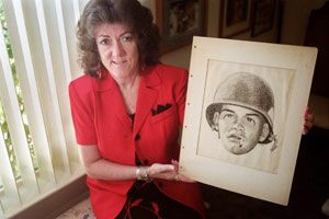 Linda Wicksten holding the sketch of Tom Roth